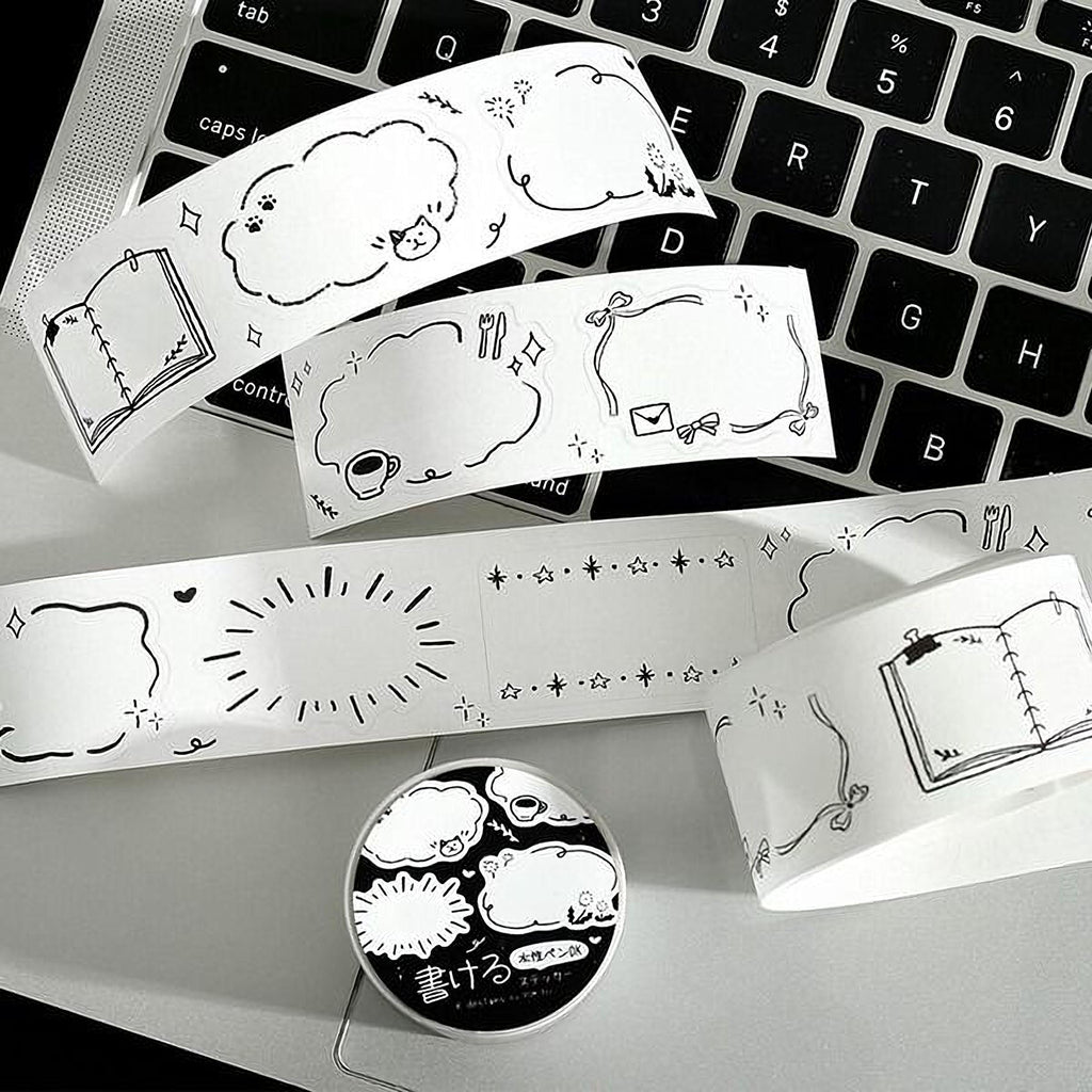 a collection of various doodle stickers and a round object with Japanese text on it, all placed on a computer keyboard.