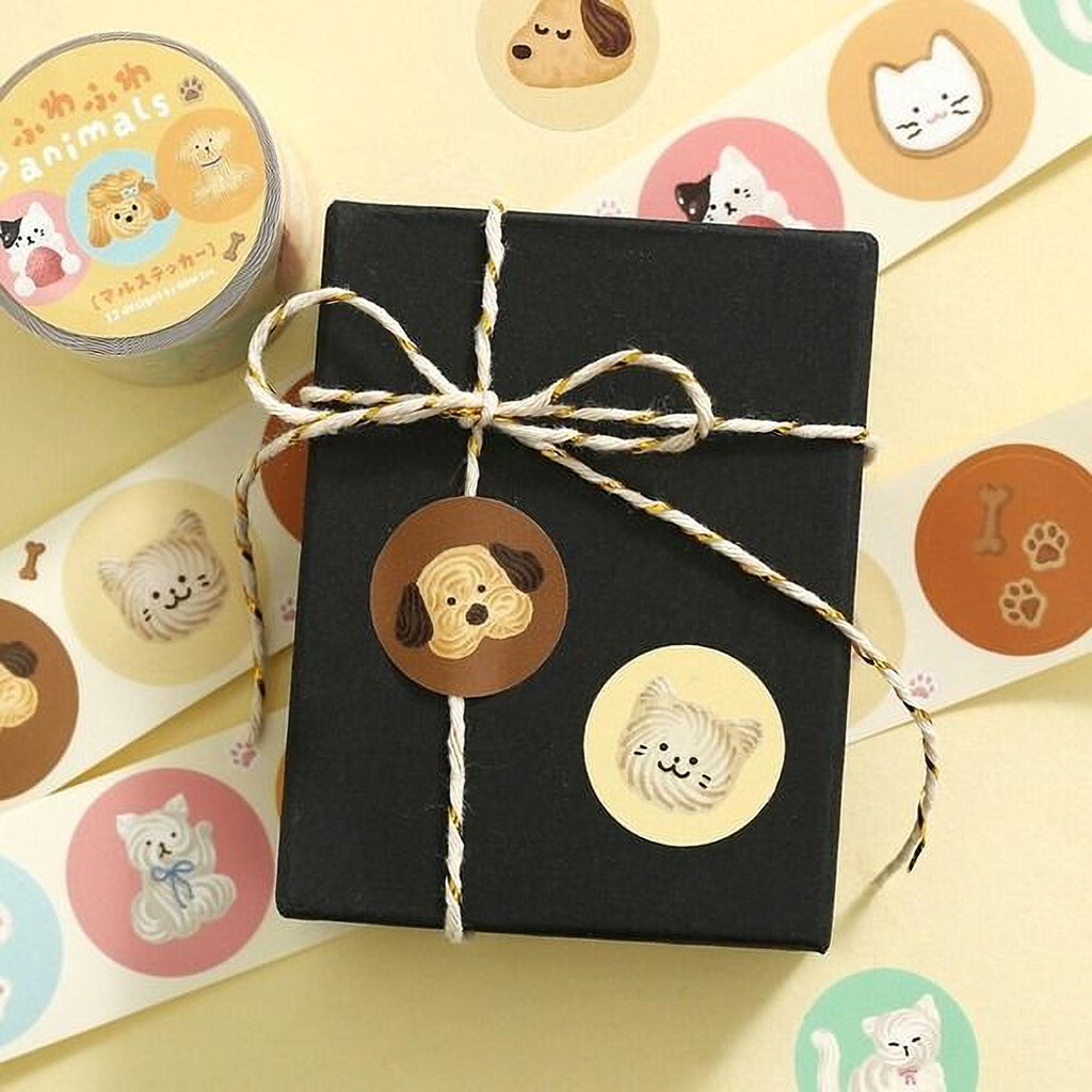 a black box with a bow, surrounded by various animal stickers, including dog, cat, and bone stickers.