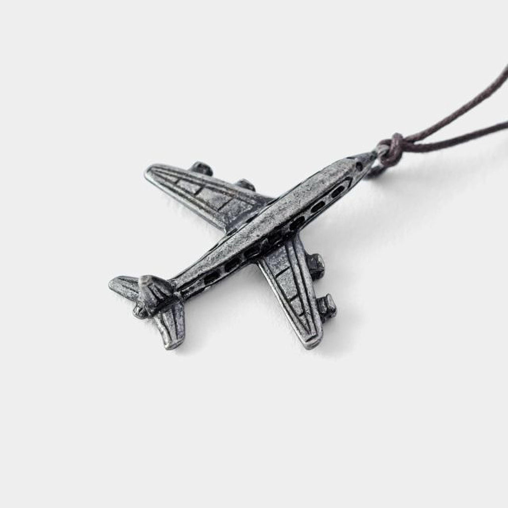 A silver-colored metal airplane pendant is shown against a white background.