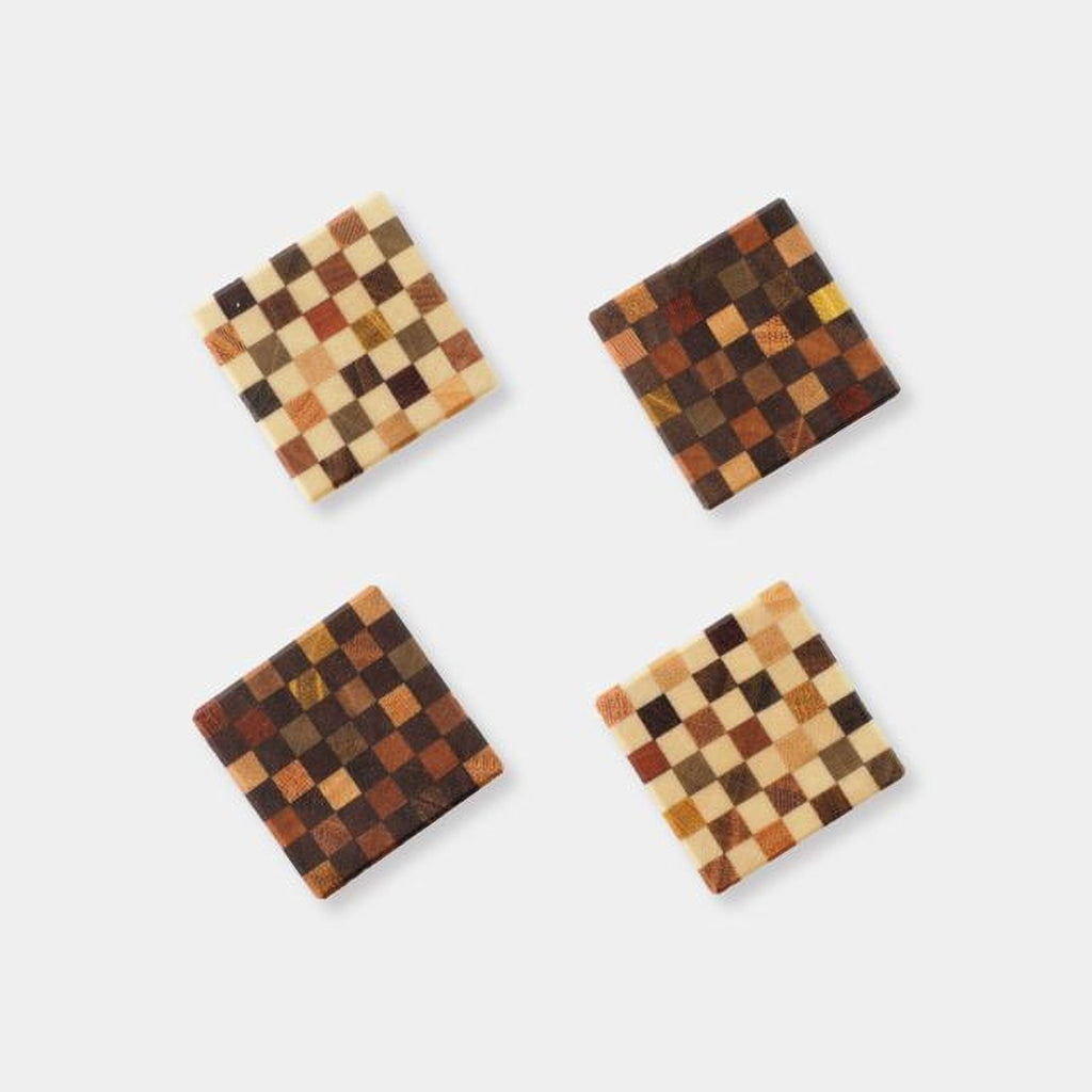 four square coasters with a checkered pattern, arranged in a square formation against a white background.