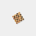 A square-shaped coaster with a checkered pattern of brown and beige squares.