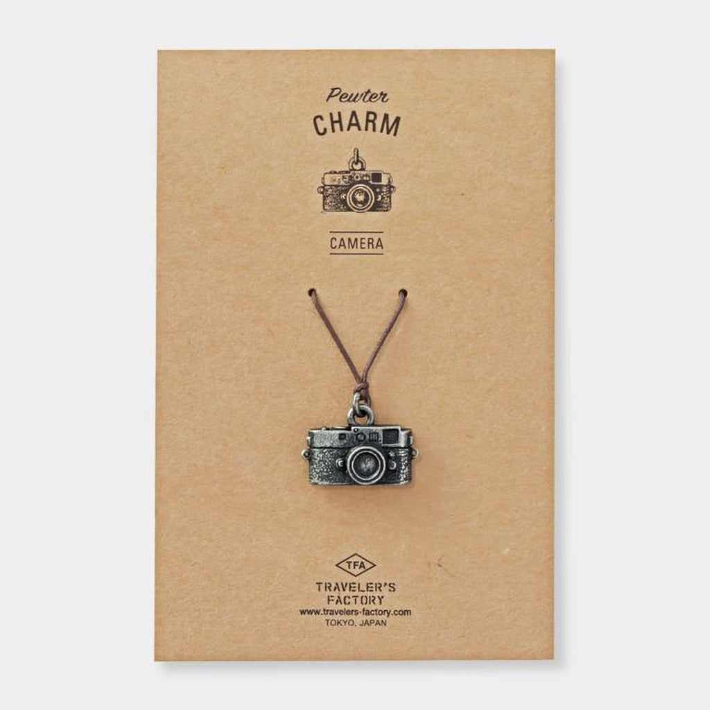 a pendant in the shape of a camera, which is a charm.