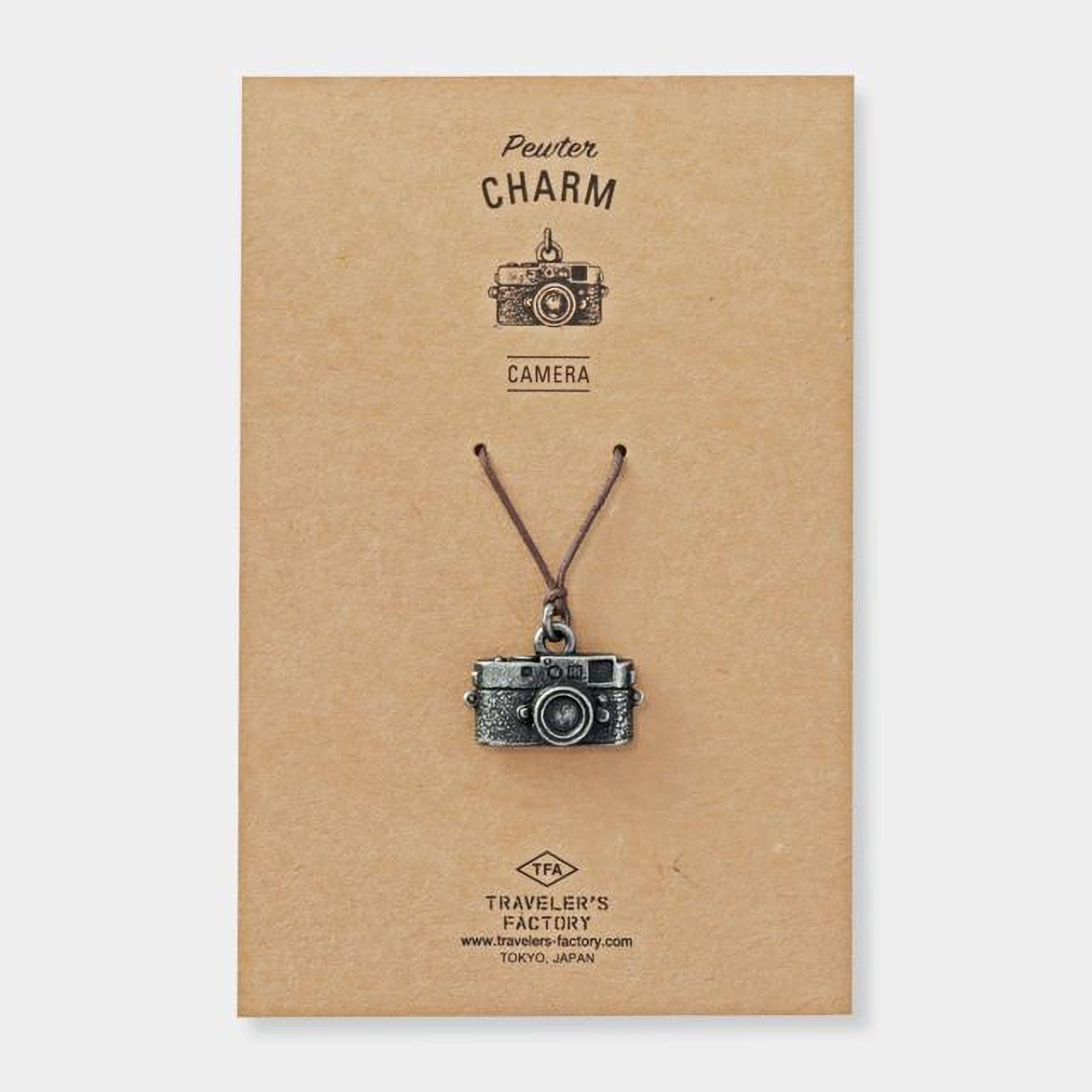 a pendant in the shape of a camera, which is a charm.