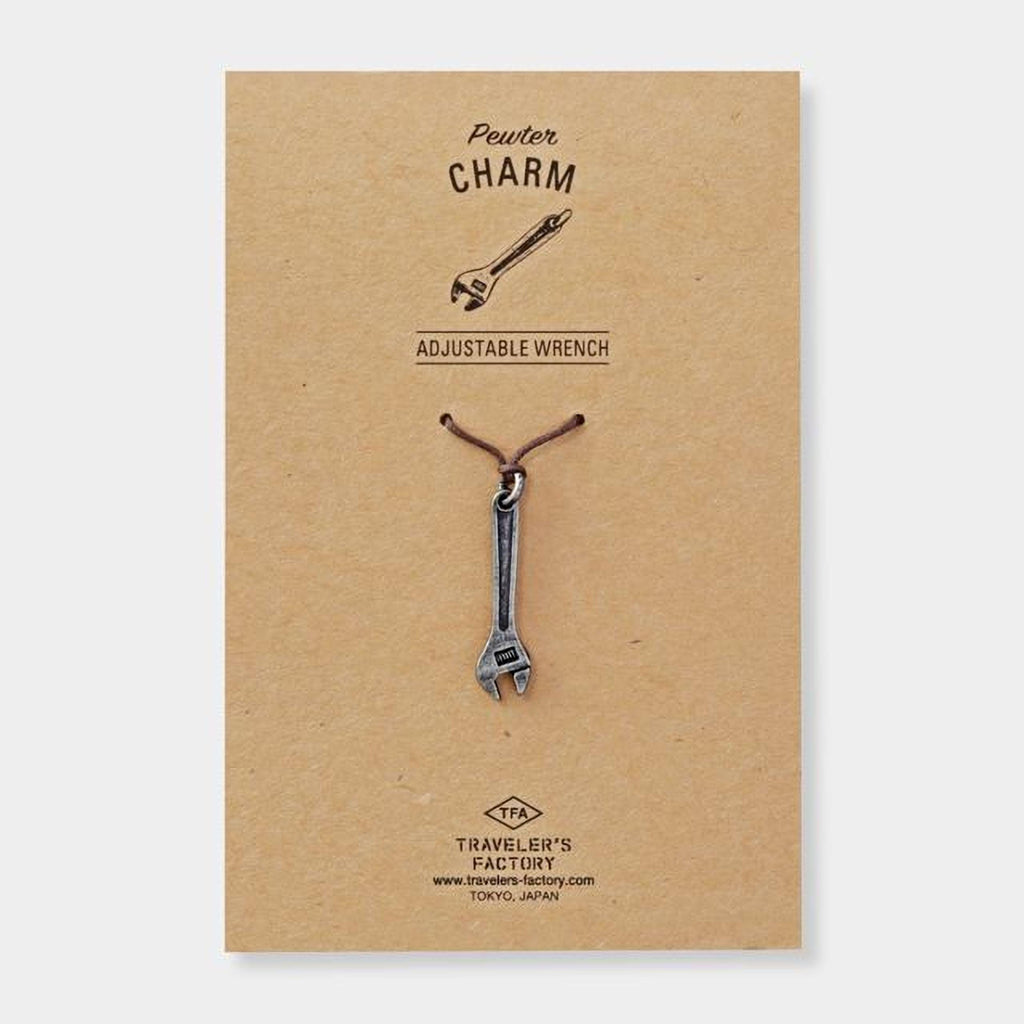 a pendant in the shape of a wrench, which is a charm.