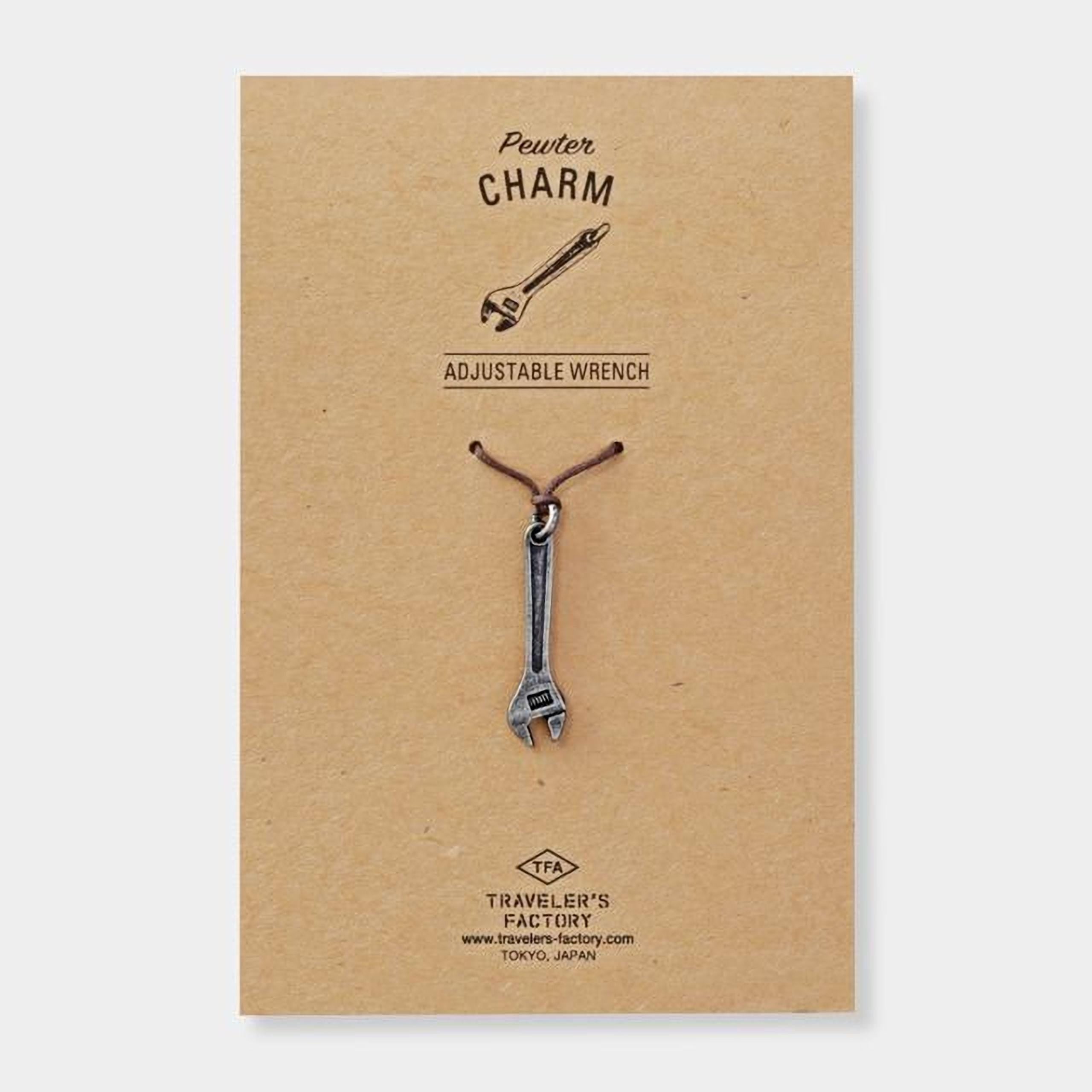a pendant in the shape of a wrench, which is a charm.