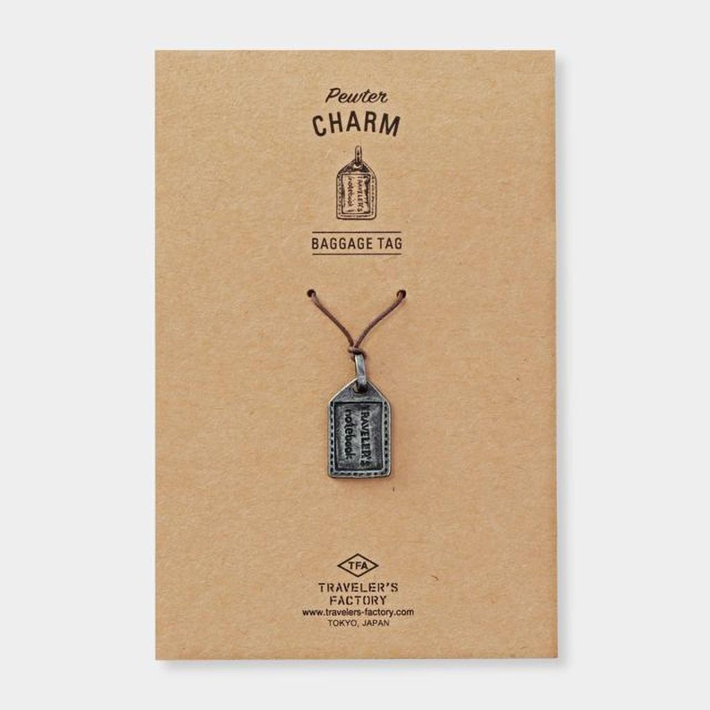 a brown cardboard box with a silver charm attached to it. The charm appears to be a small metal tag or pendant.