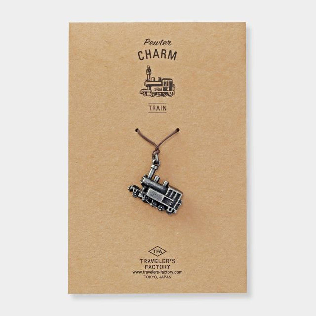 a charm in the shape of a train, hanging from a string.