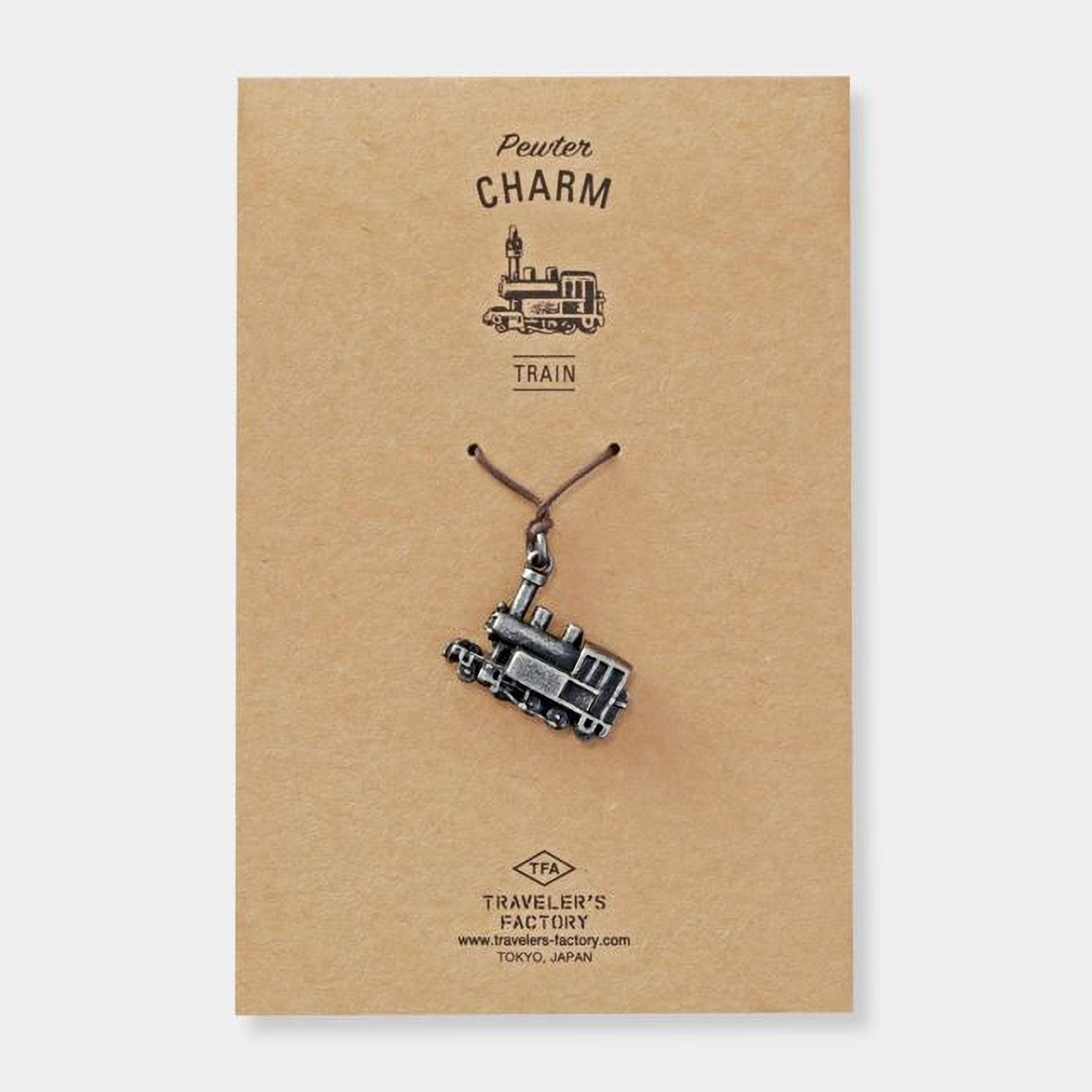 a charm in the shape of a train, hanging from a string.