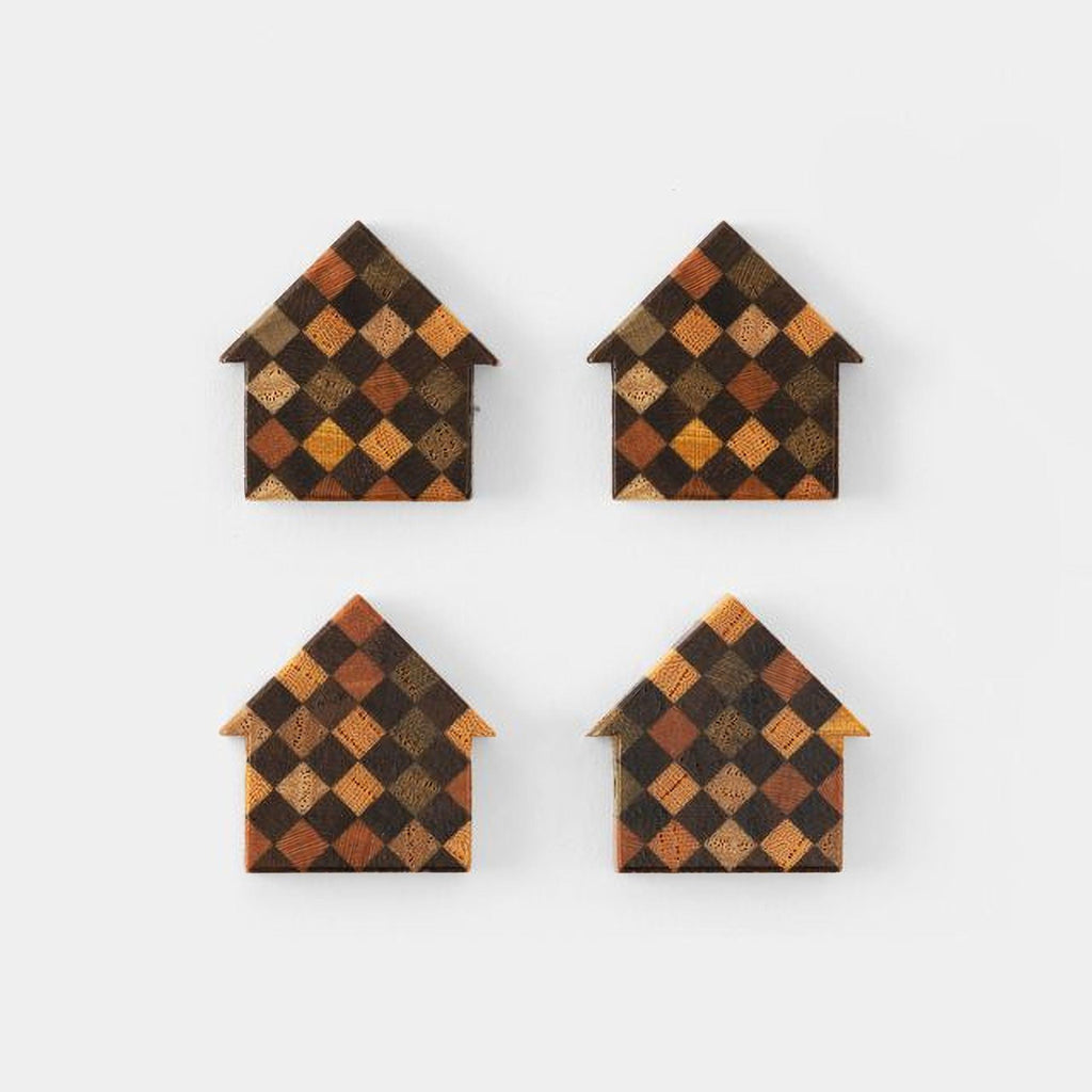 four identical wooden house-shaped objects with a checkered pattern in various shades of brown and orange.