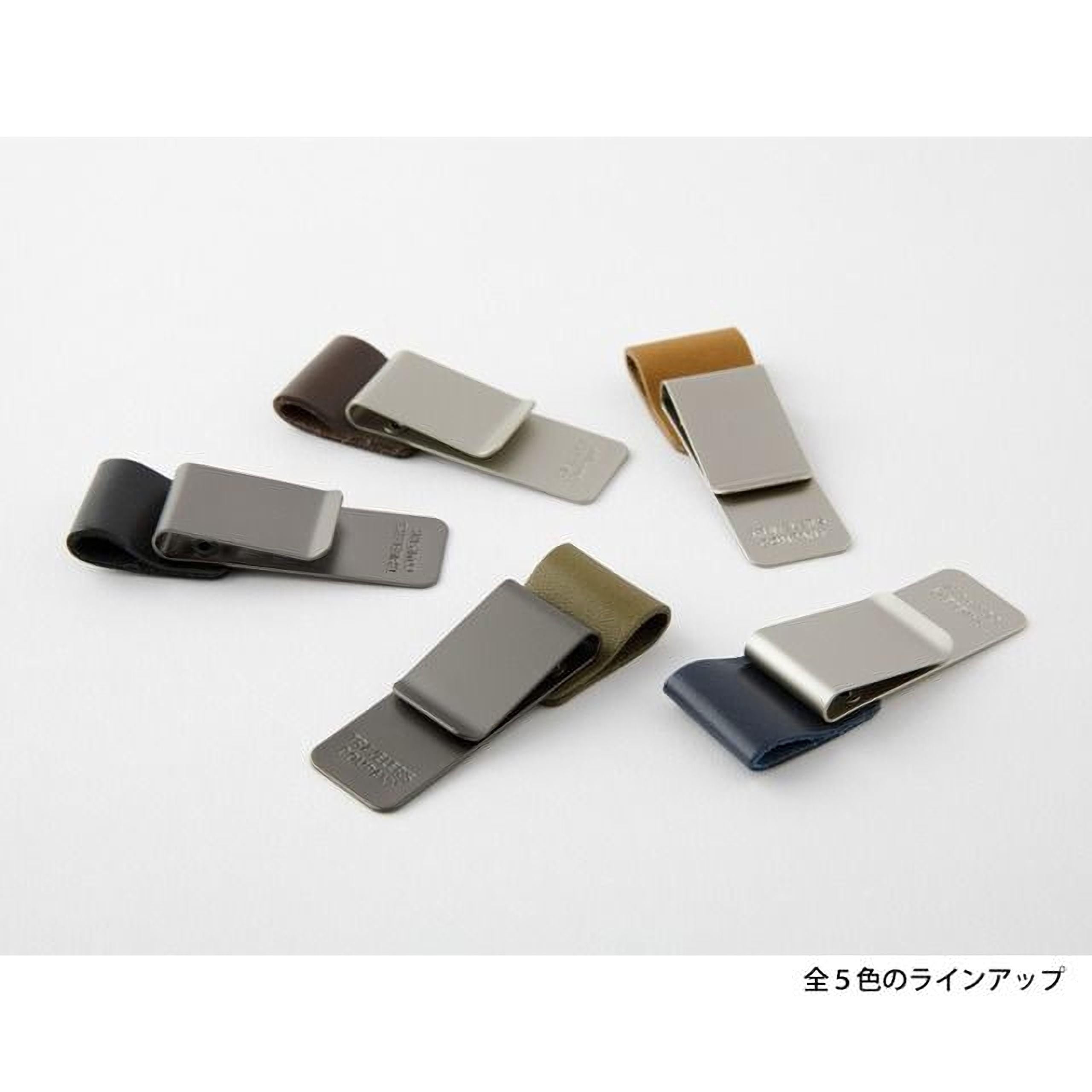 a collection of six different colored and patterned clipboards or money clips, each with a unique design and color.