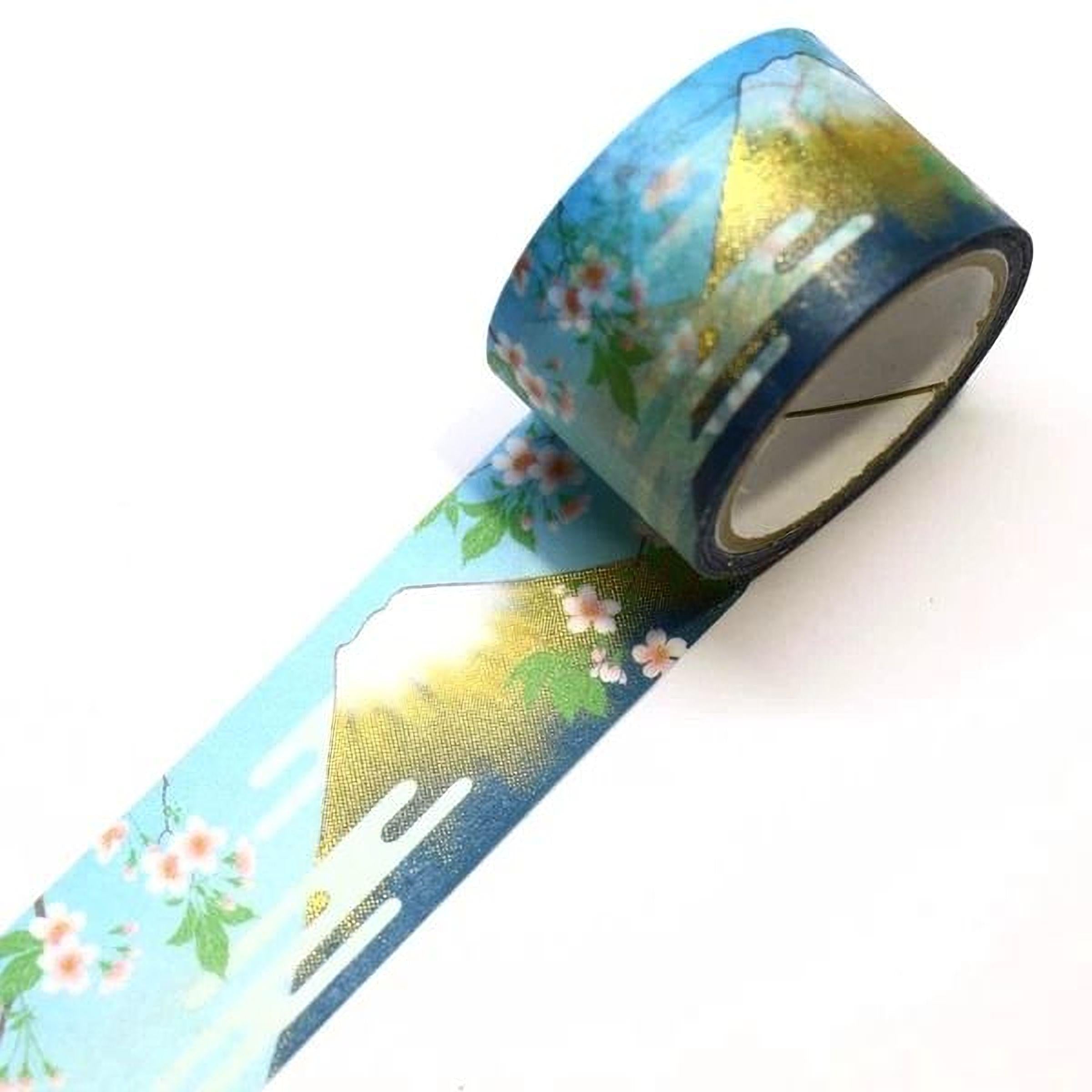 A roll of blue and gold tape with a floral pattern, featuring a mountain landscape design.