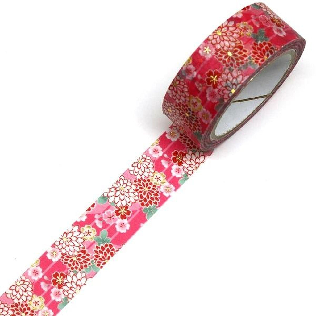 A roll of red and white floral patterned tape is lying on a white surface.