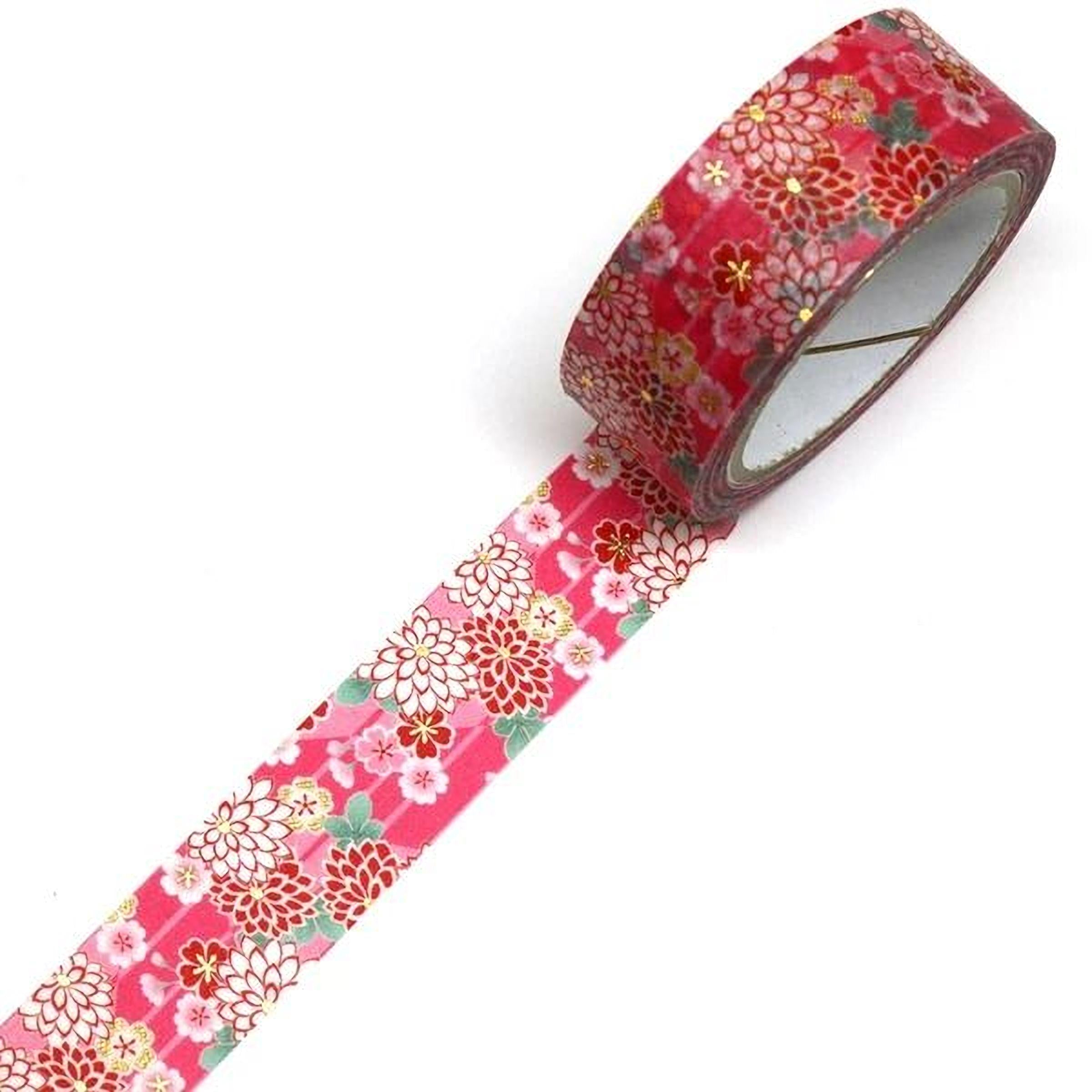 A roll of red and white floral patterned tape is lying on a white surface.