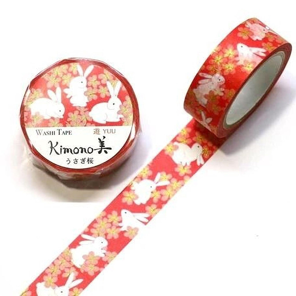 a roll of red washi tape with a pattern of white rabbits on a red background.