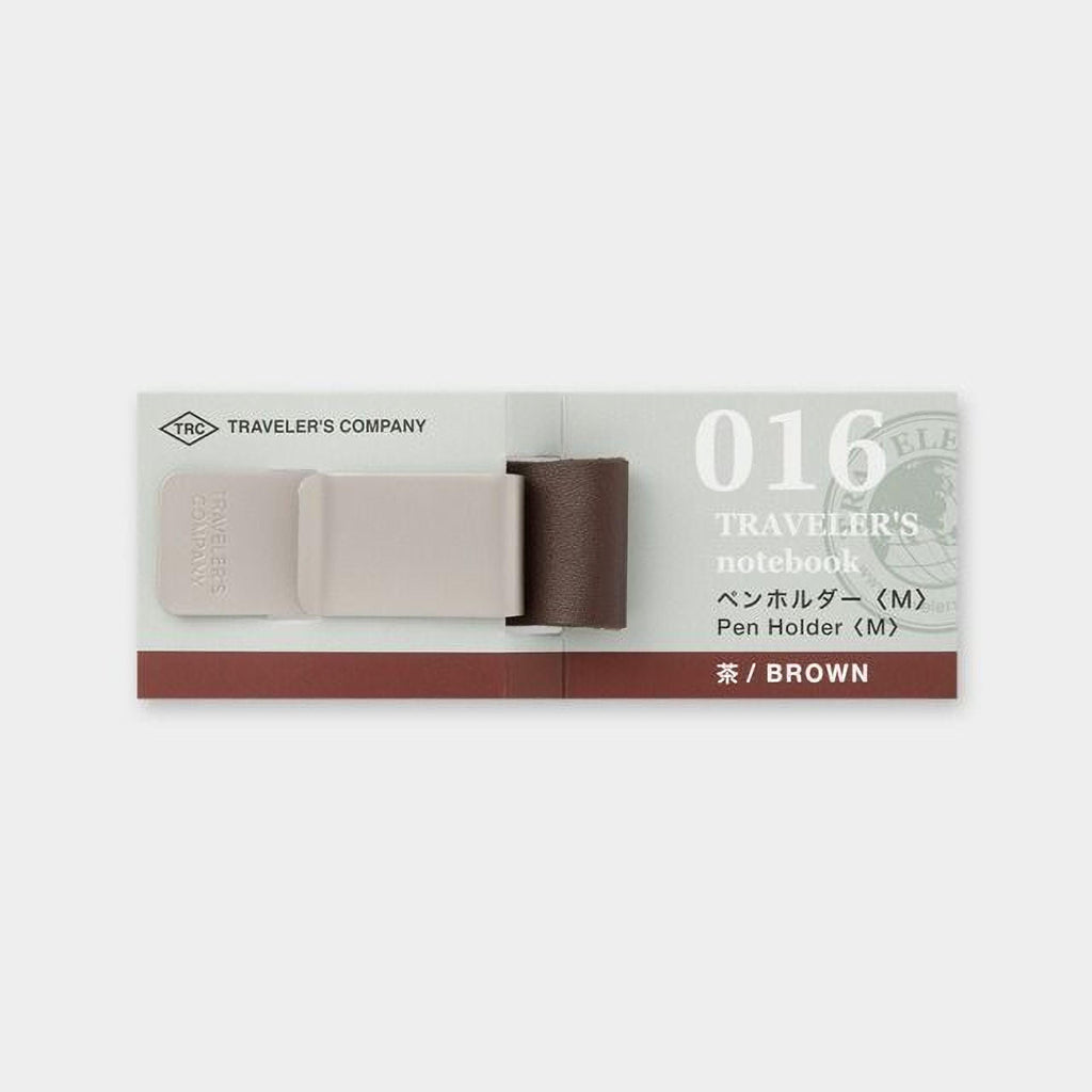 a brown pen holder with a brown strap, designed for use with a traveler's notebook.