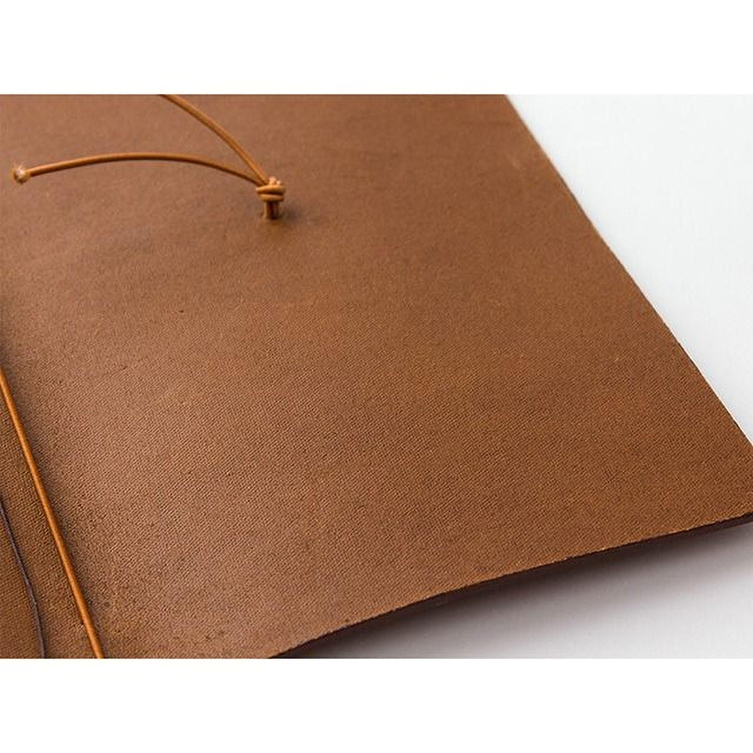 a close-up view of a brown leather surface, possibly a piece of paper or a fabric.