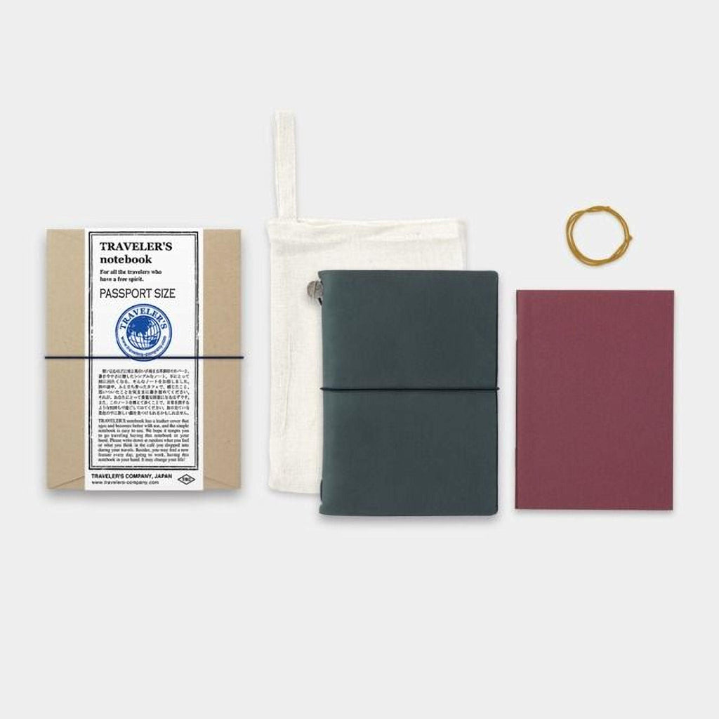 a variety of travel-related items, including a passport-sized notebook, a passport holder, a red notebook, and a yellow string.