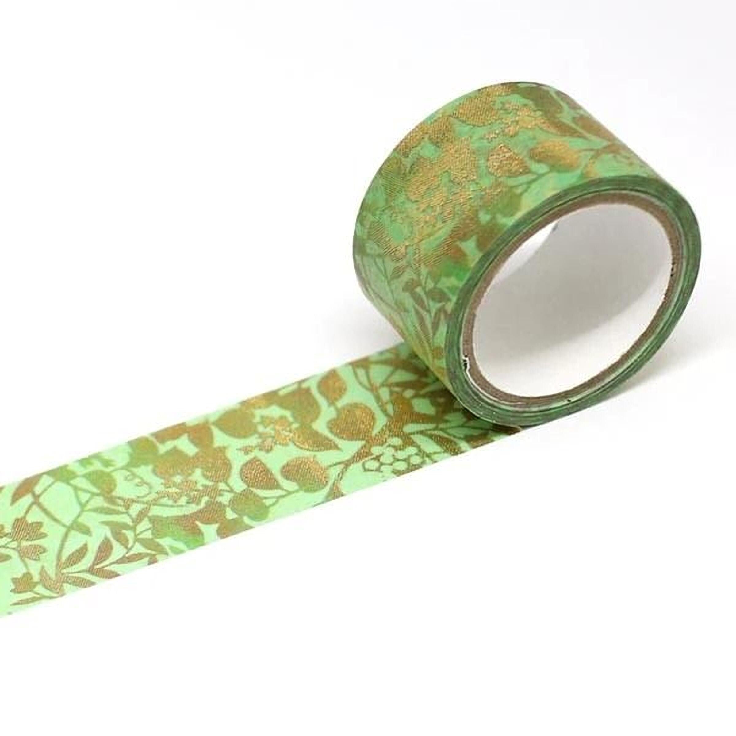 A roll of green and gold patterned tape is shown against a white background.