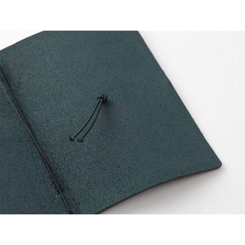 A close-up view of a dark green, textured surface with a small knot or loop at the top.