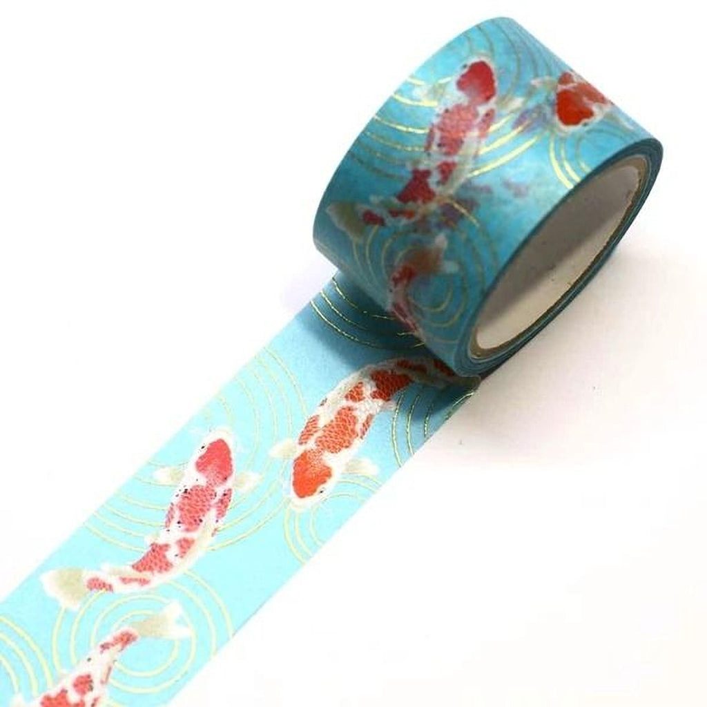 A roll of blue and gold patterned tape with a design of red and white koi fish.