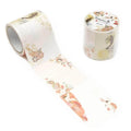 a roll of decorative tape with a floral pattern and a small container of the same tape.