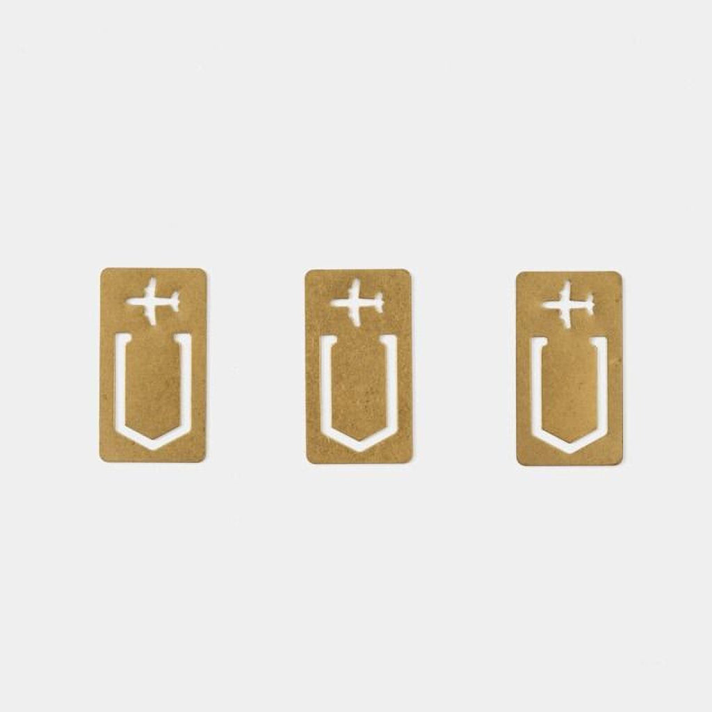 Three identical gold-colored paper clips with white airplane symbols on them.