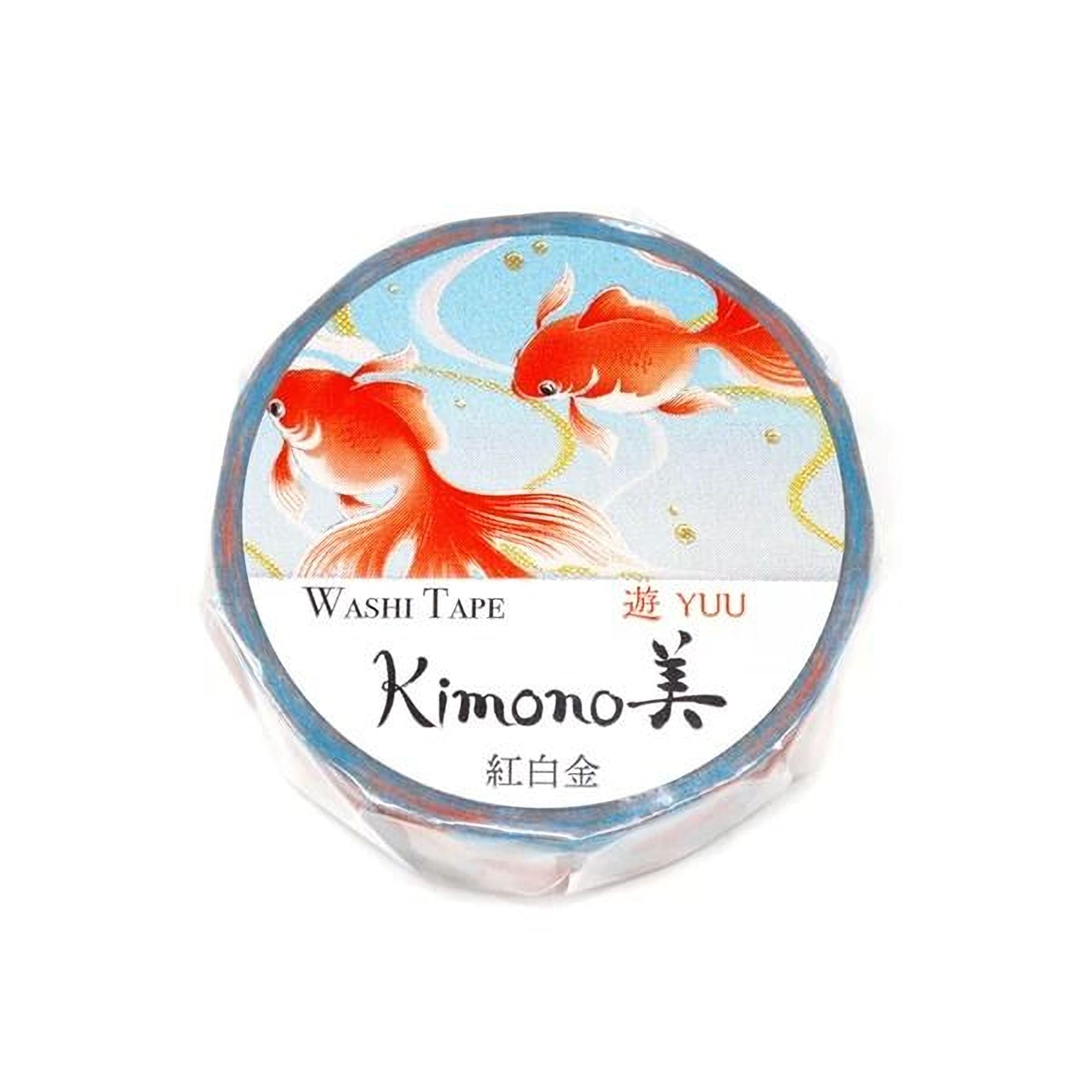 a round, blue and white label with a design of two orange fish swimming in a blue background. The label has text that reads "Washi Tape Kimono" and "YUU", indicating that it is a product from the brand Kimono.