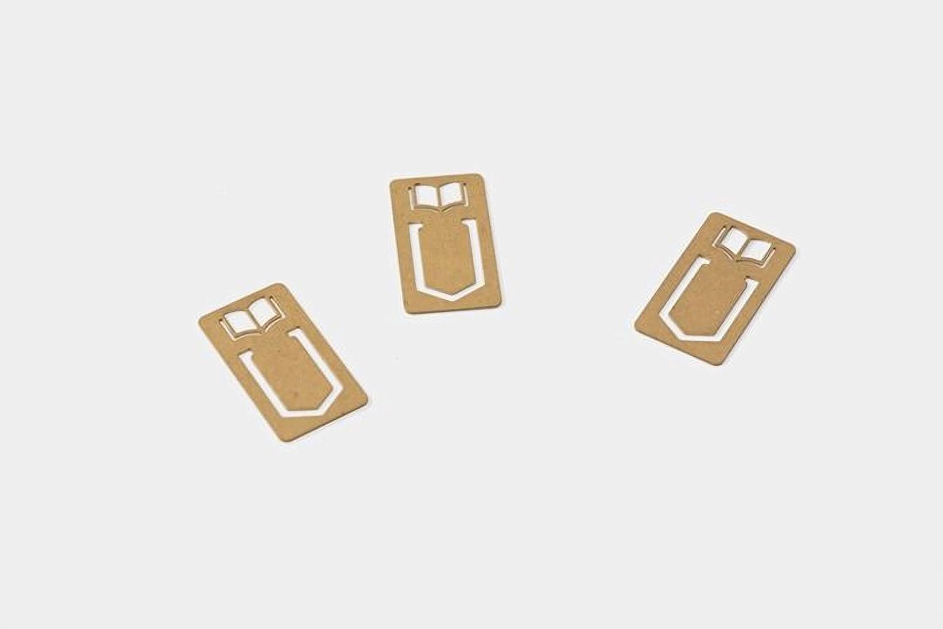 Three identical gold-colored bookmarks with white book symbols are arranged in a triangular formation on a white background.
