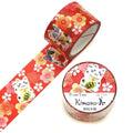 a roll of red and white floral patterned washi tape and a round container of the same tape.