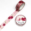 a roll of pink and white floral patterned washi tape and a round container of the same type of tape.