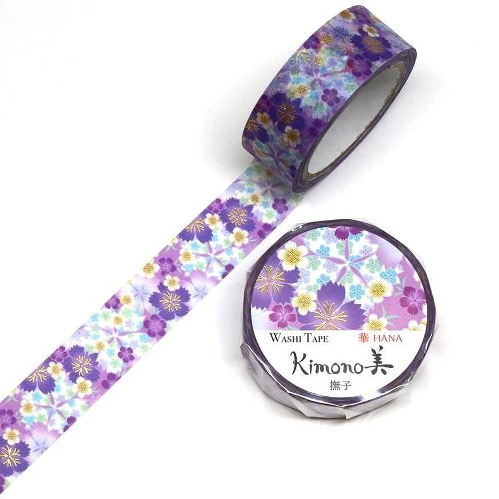 a roll of purple and white floral patterned washi tape and a round container of the same type of tape.