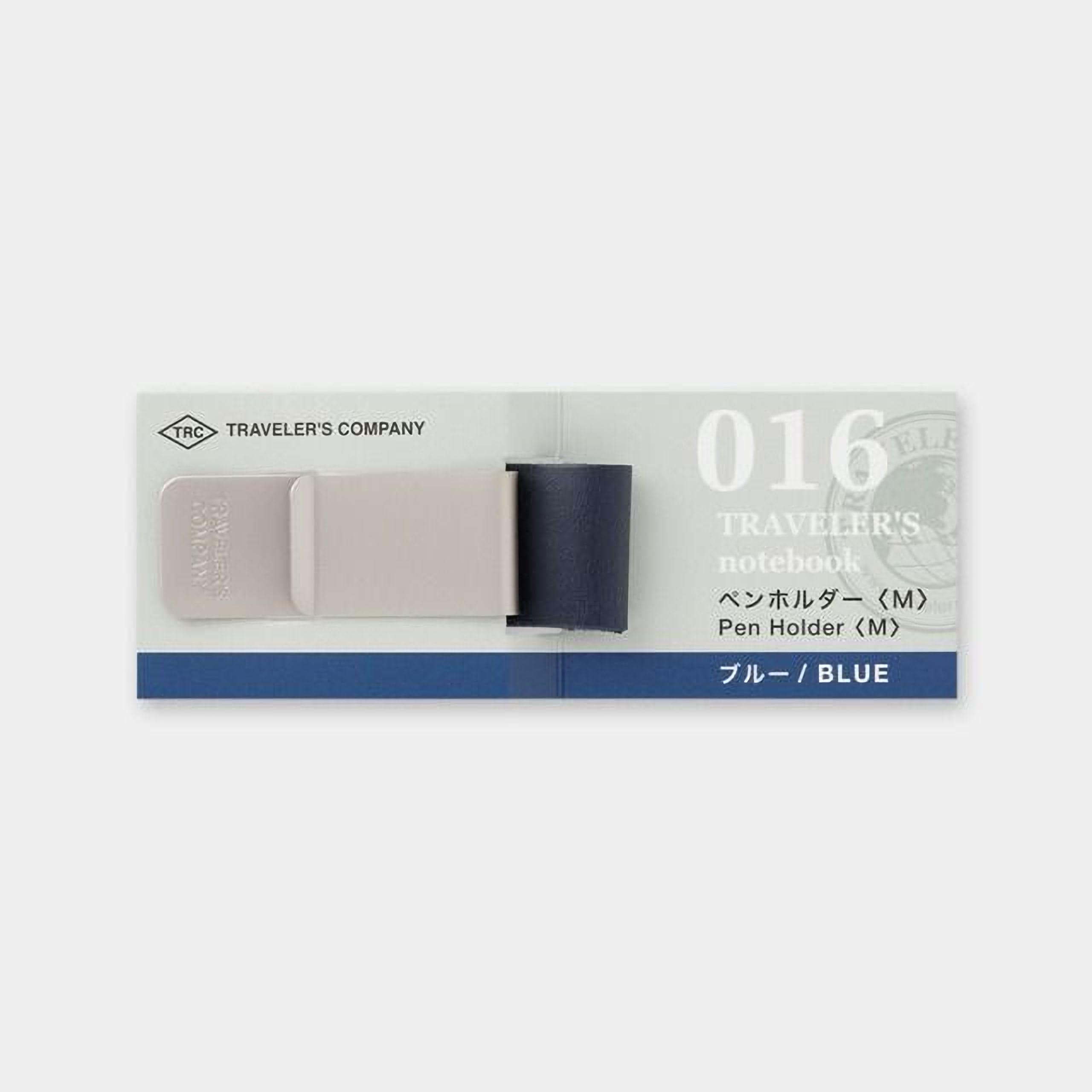 a blue and white notebook pen holder with a grey base, designed by TRAVELER'S COMPANY.
