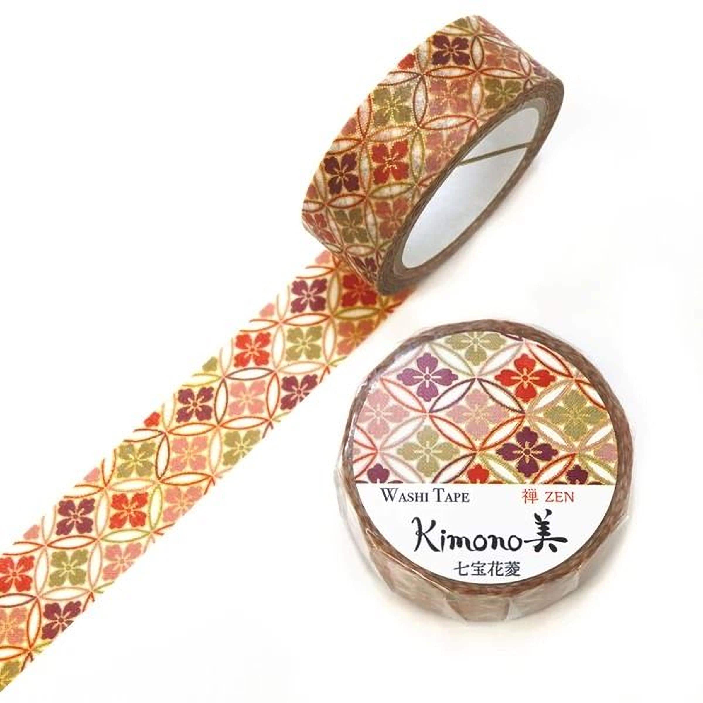two rolls of washi tape with a floral pattern, one roll is lying on its side and the other is standing upright.