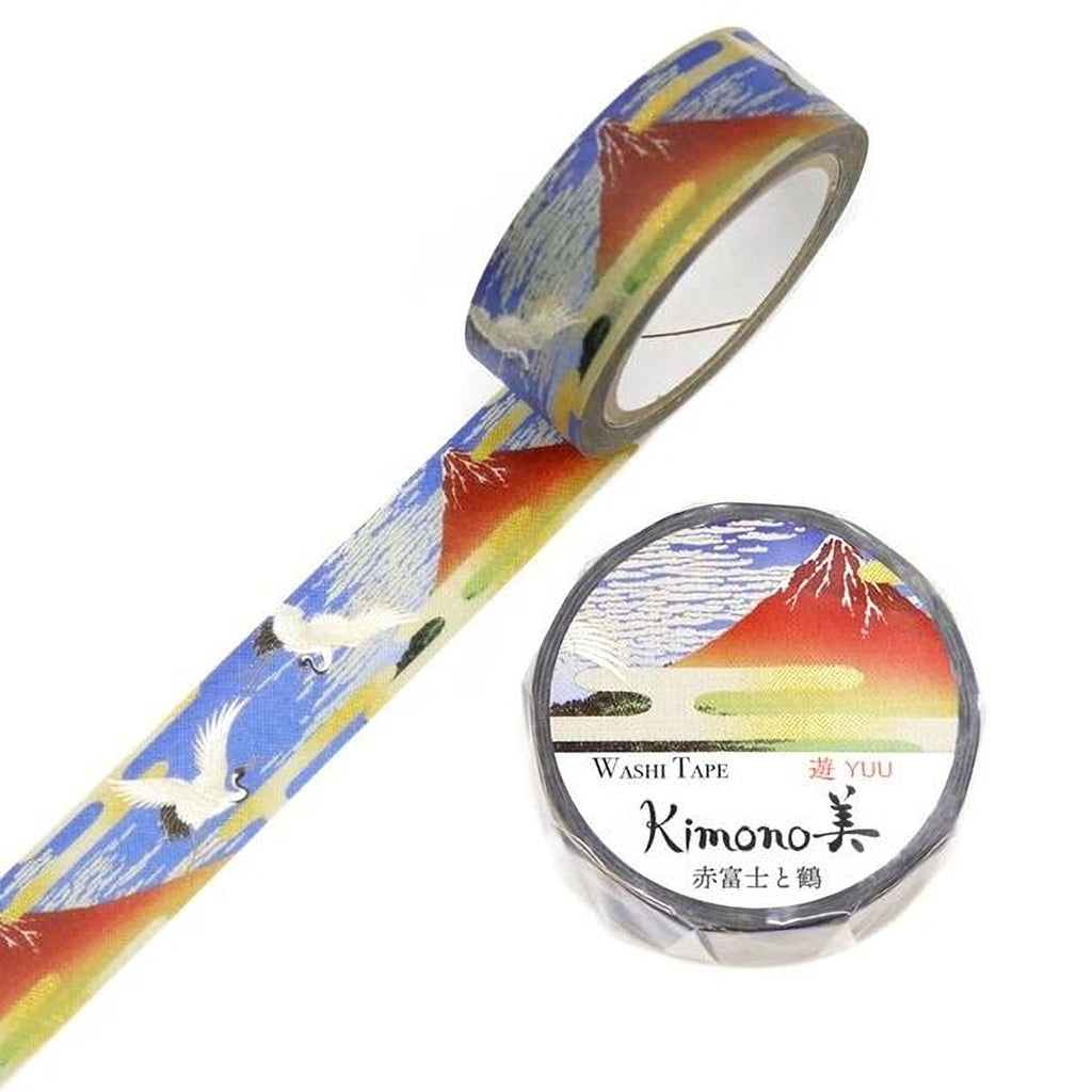 a roll of washi tape with a Japanese mountain landscape design and a round container of Kimono washi tape.