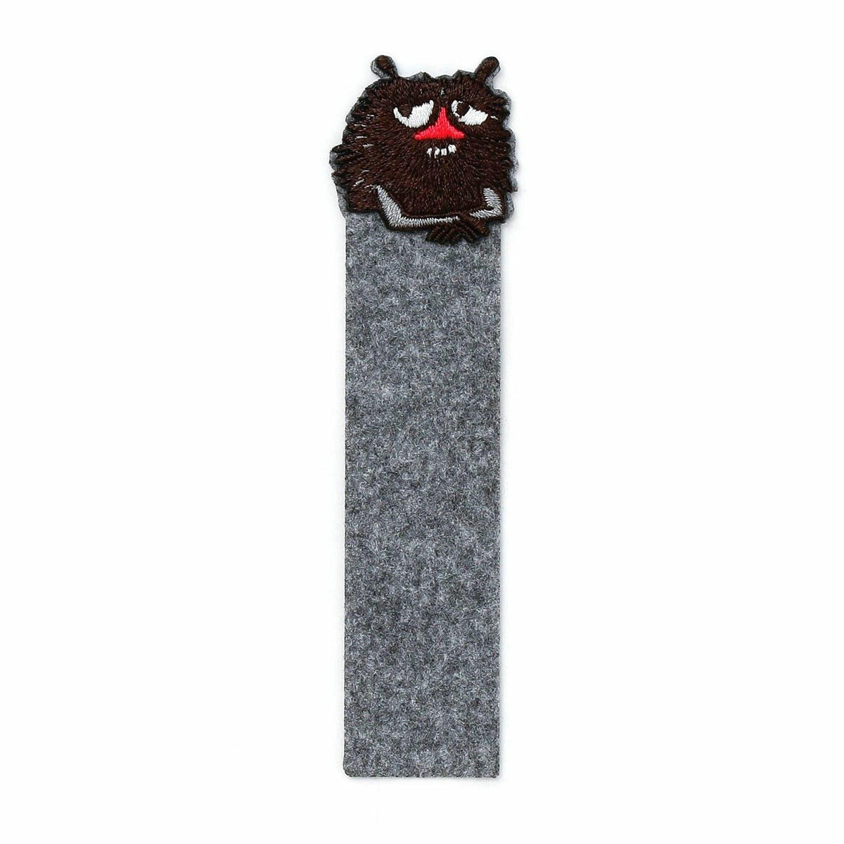 A gray felt bookmark with a brown, furry creature resembling a cat or a small animal peeking out from behind it.