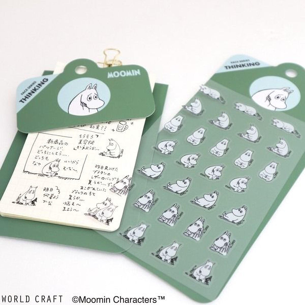 a collection of stickers and a notebook with a character design, likely from the Moomin character series.