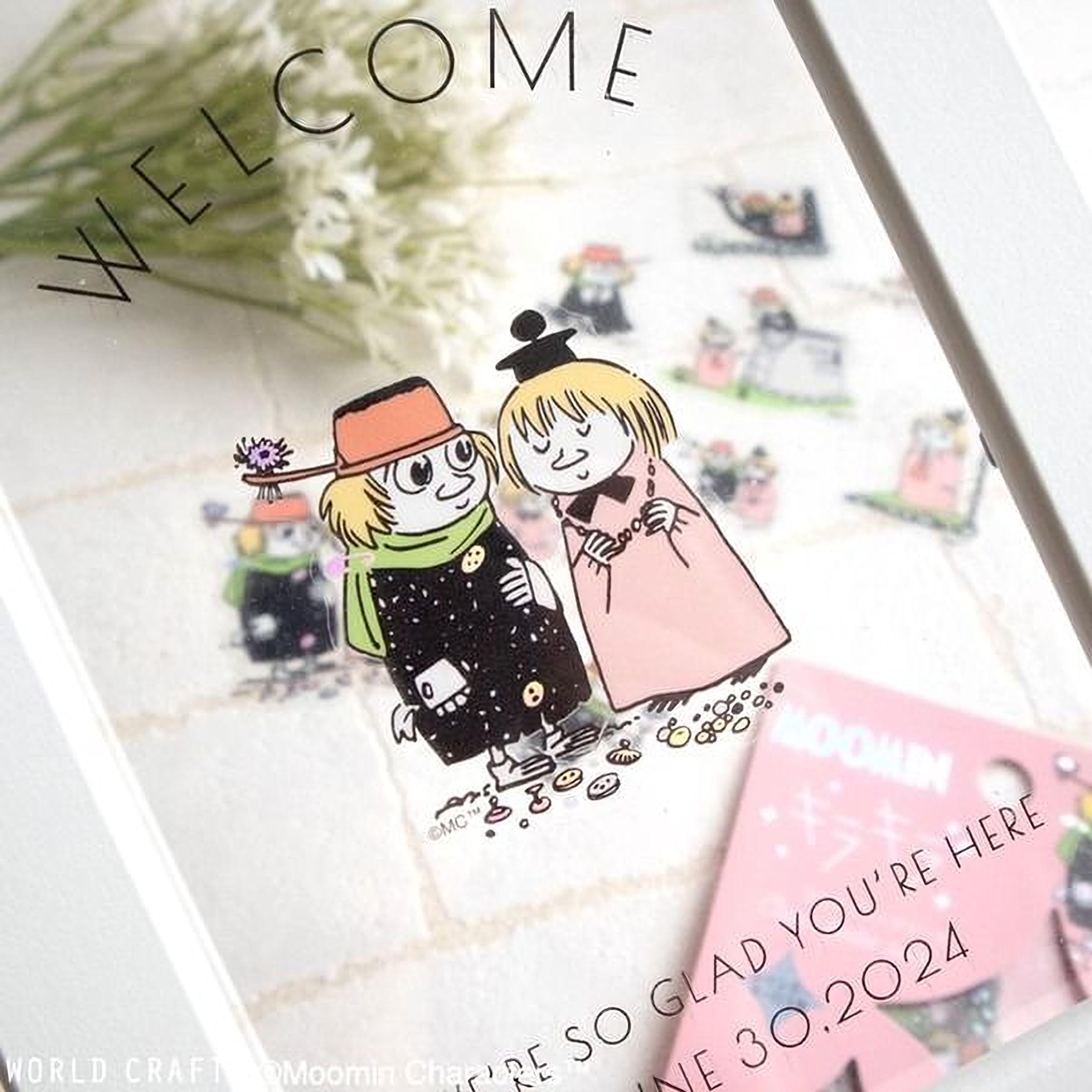 The image is a framed artwork featuring two cartoon characters, one wearing a black outfit and the other in a pink outfit, standing together. The background of the artwork includes various other cartoon characters and objects, creating a colorful and lively scene.