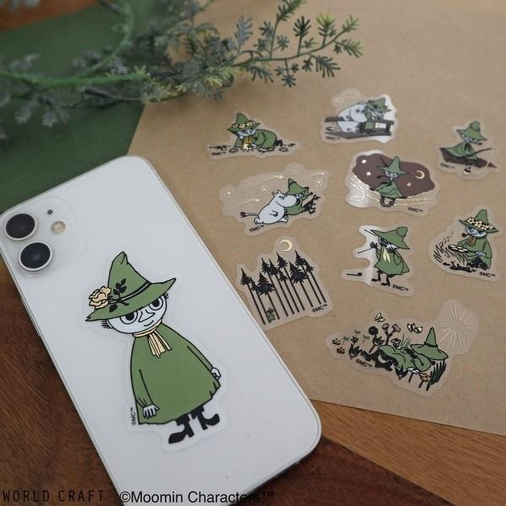 a white iPhone case with a green character sticker on it, along with several other stickers depicting various characters and scenes.