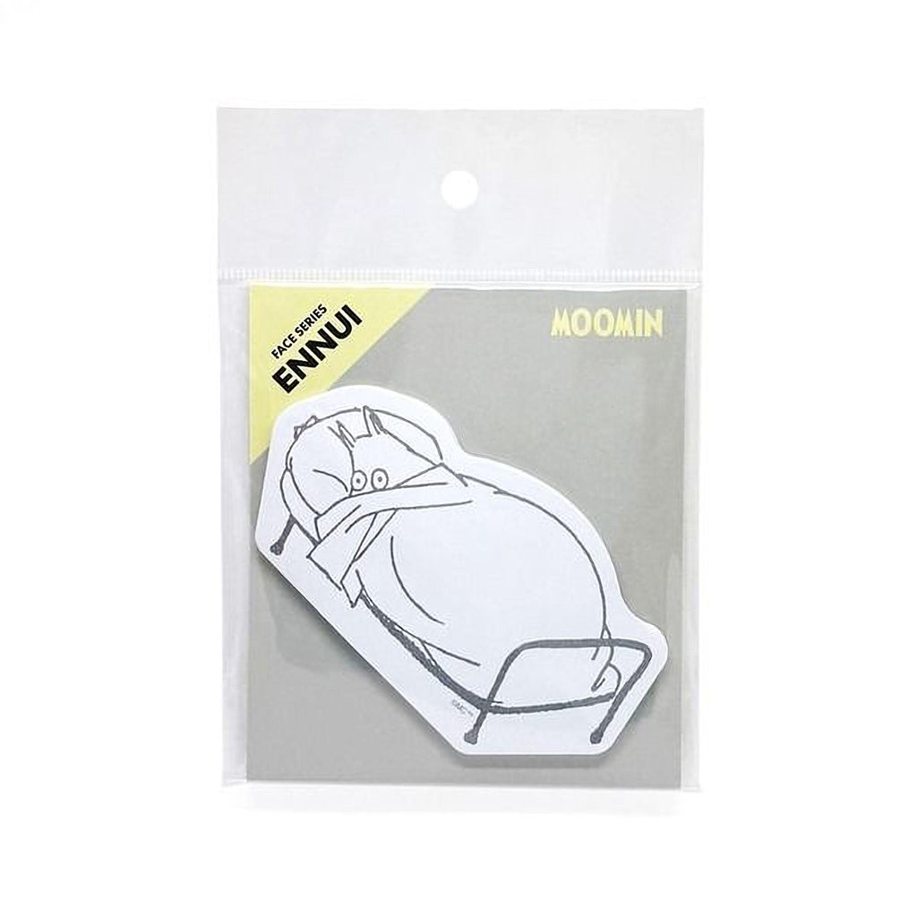 A sticker depicting a cartoon illustration of a cat sleeping on a bed.