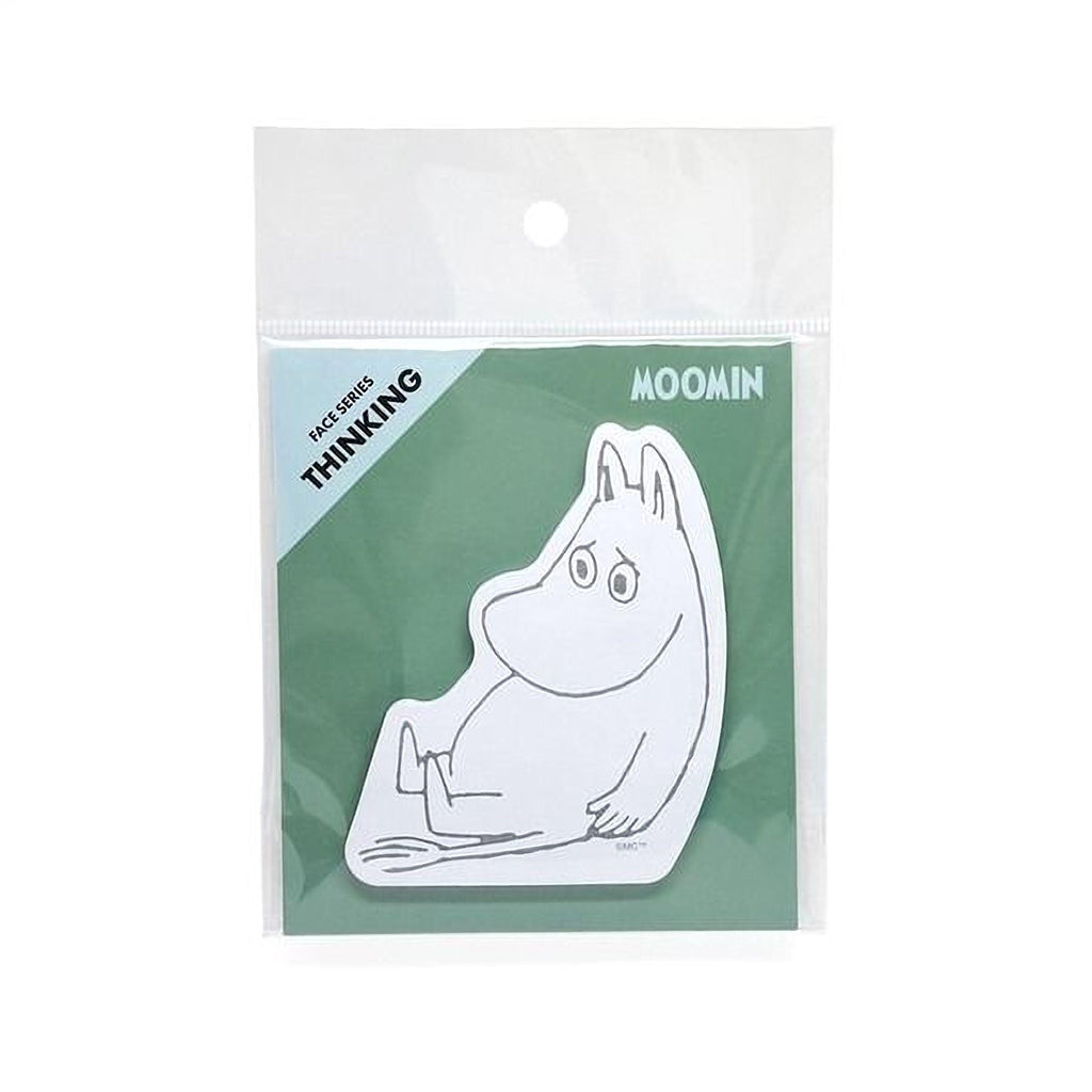 A sticker depicting a cartoon character, likely Moomin, sitting on a green background.