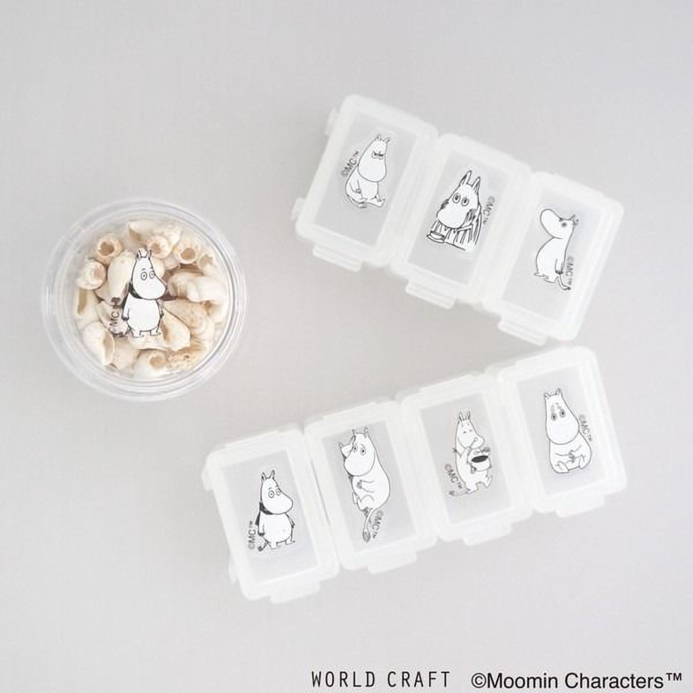 a collection of small containers with illustrations of Moomin characters, along with a small bowl containing seashells.