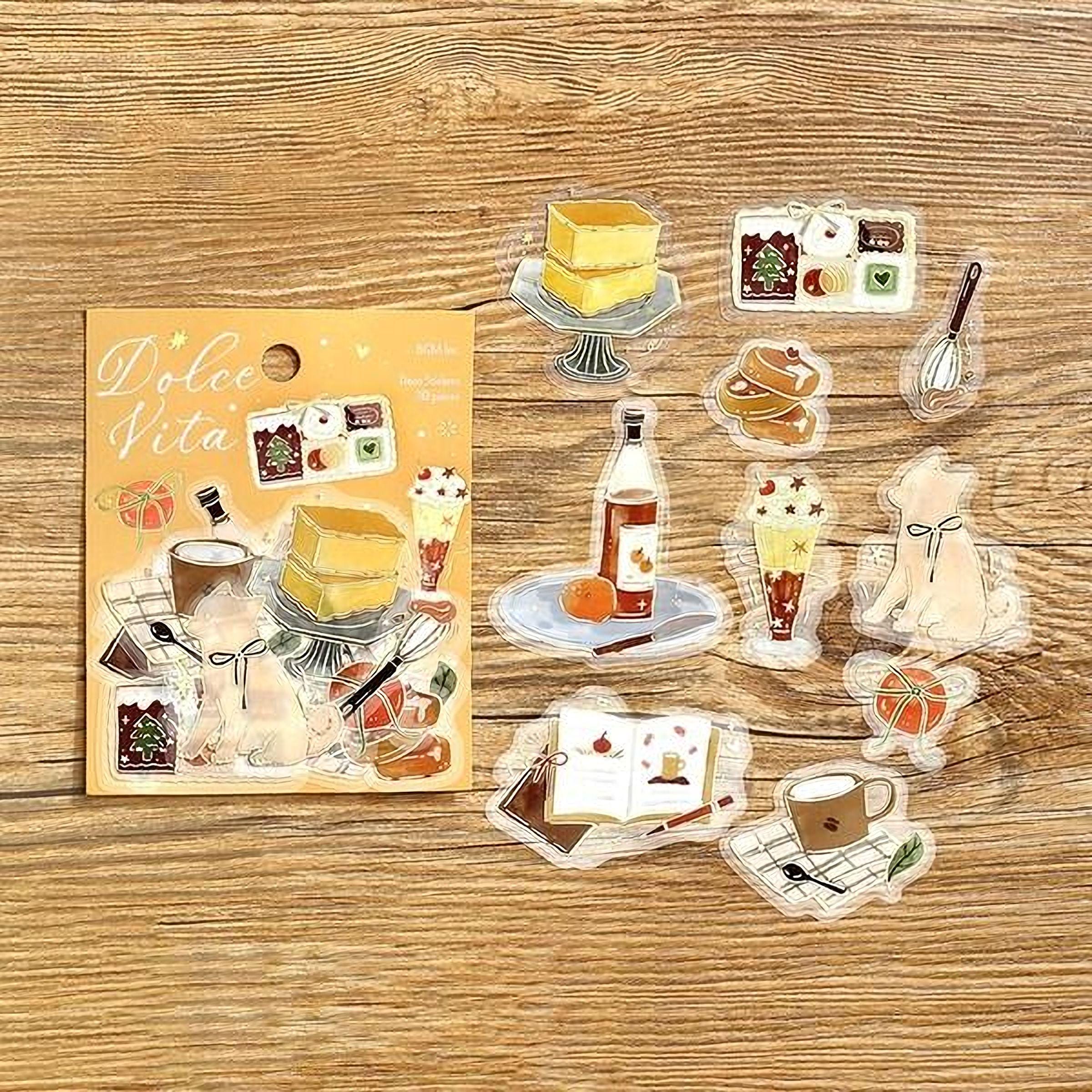a collection of various food and drink items, including cakes, bottles, cups, and spoons, arranged on a wooden surface.