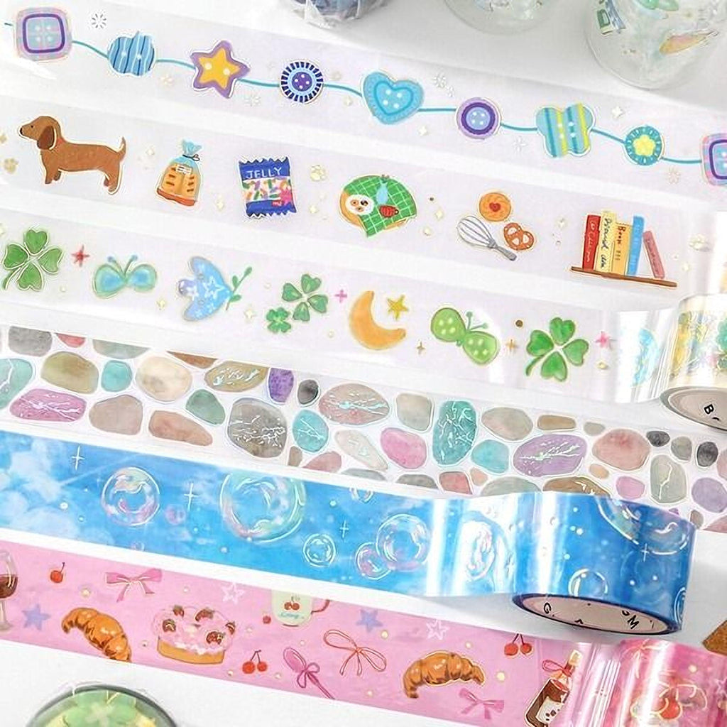 a variety of colorful and patterned tape rolls, each with different designs and illustrations, including stars, hearts, and other decorative elements.
