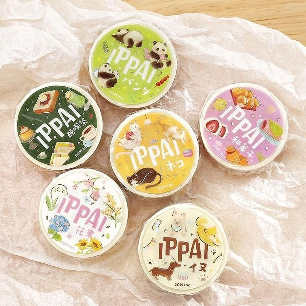 six circular containers with colorful labels, arranged on a crumpled white surface.