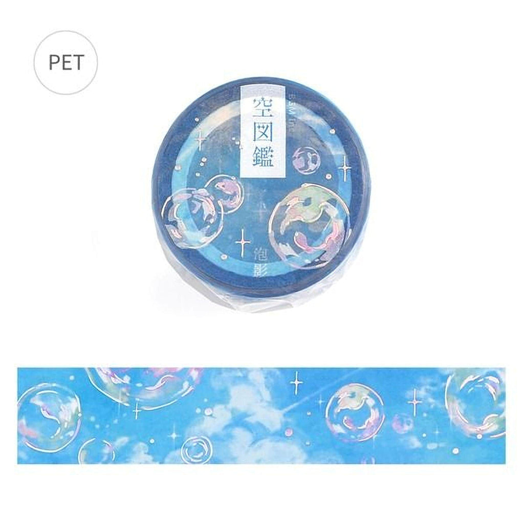 a blue circular object with a whimsical design of bubbles and stars, along with some Japanese text.