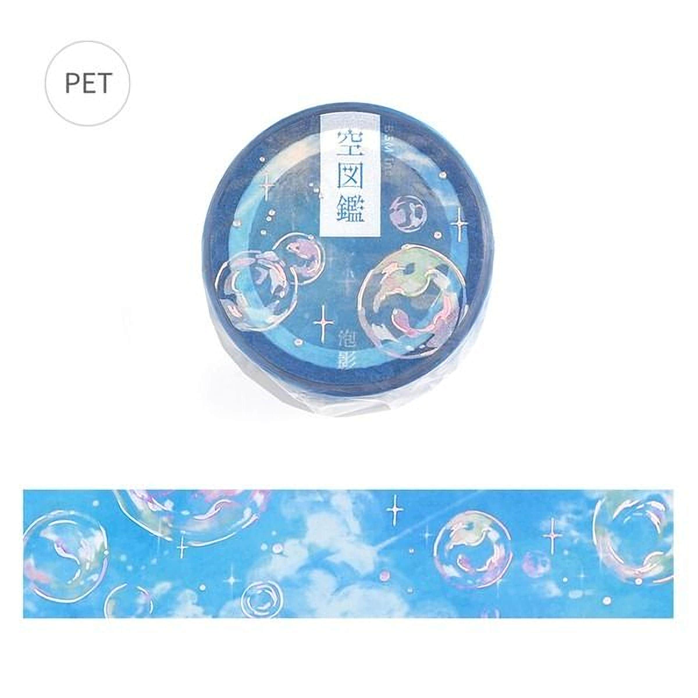 a blue circular object with a whimsical design of bubbles and stars, along with some Japanese text.