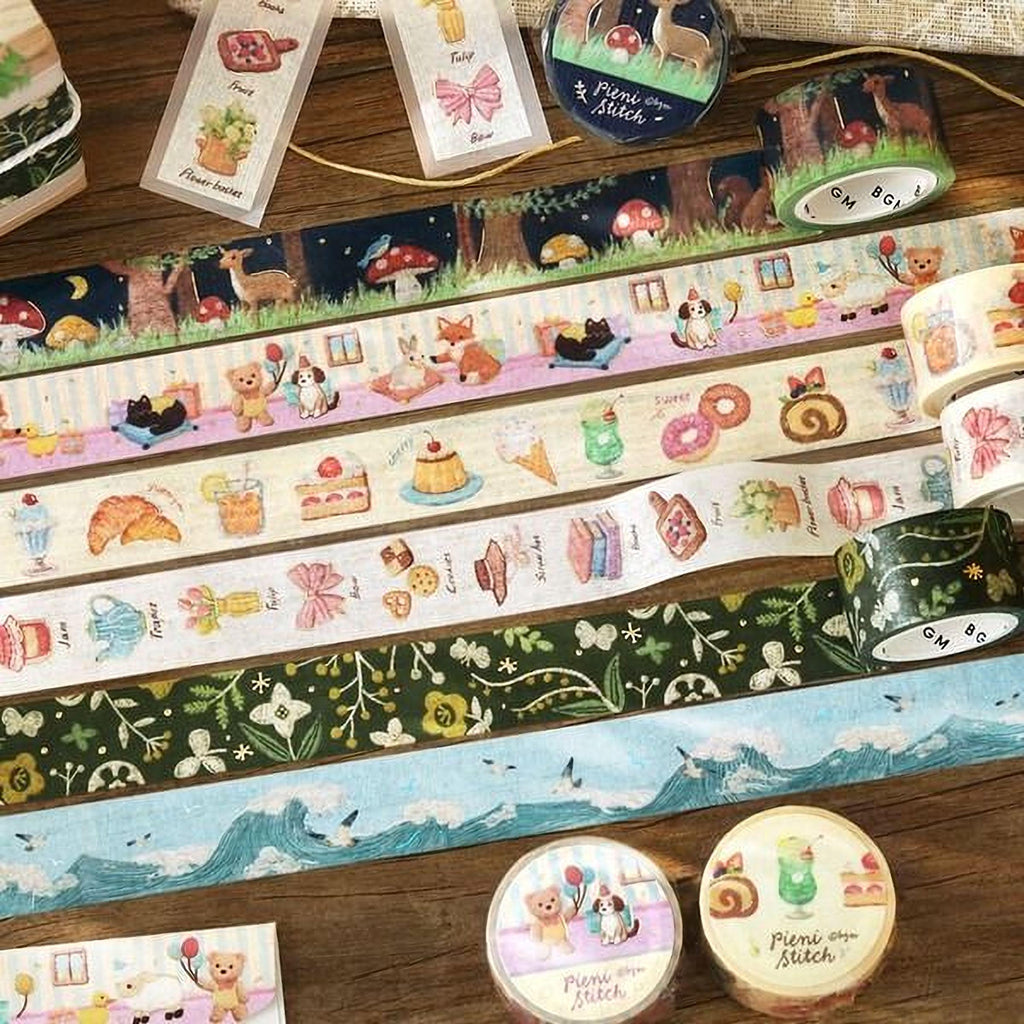 various decorative items, including a collection of colorful washi tape rolls with illustrations of animals, food, and nature scenes, as well as some other decorative elements.