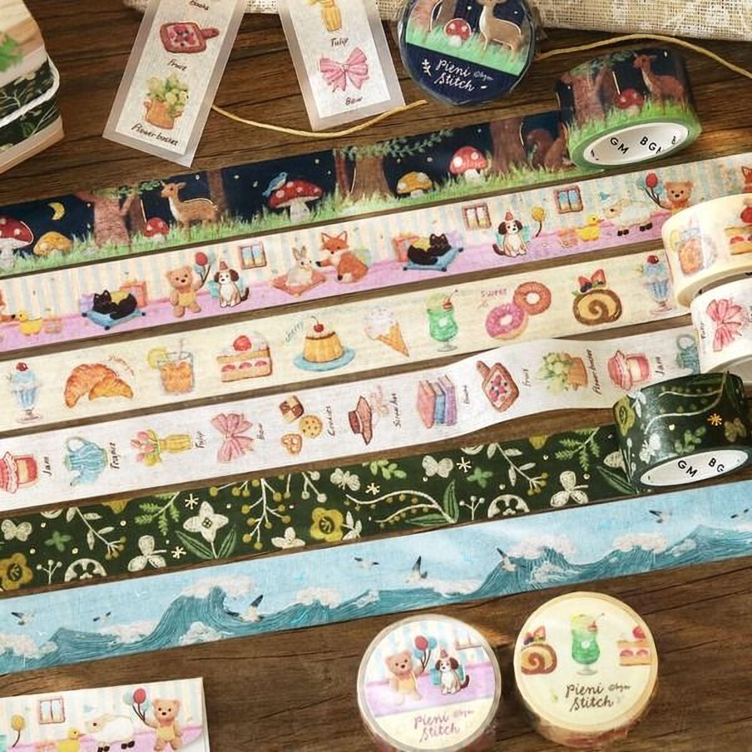 various decorative items, including a collection of colorful washi tape rolls with illustrations of animals, food, and nature scenes, as well as some other decorative elements.