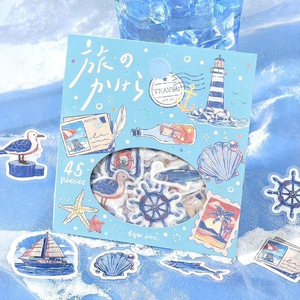 a package of 45 pieces of stickers with various nautical and marine-themed illustrations, including a lighthouse, seagull, starfish, and other sea creatures. The stickers are displayed on a blue background, and there is a glass of water in the background.