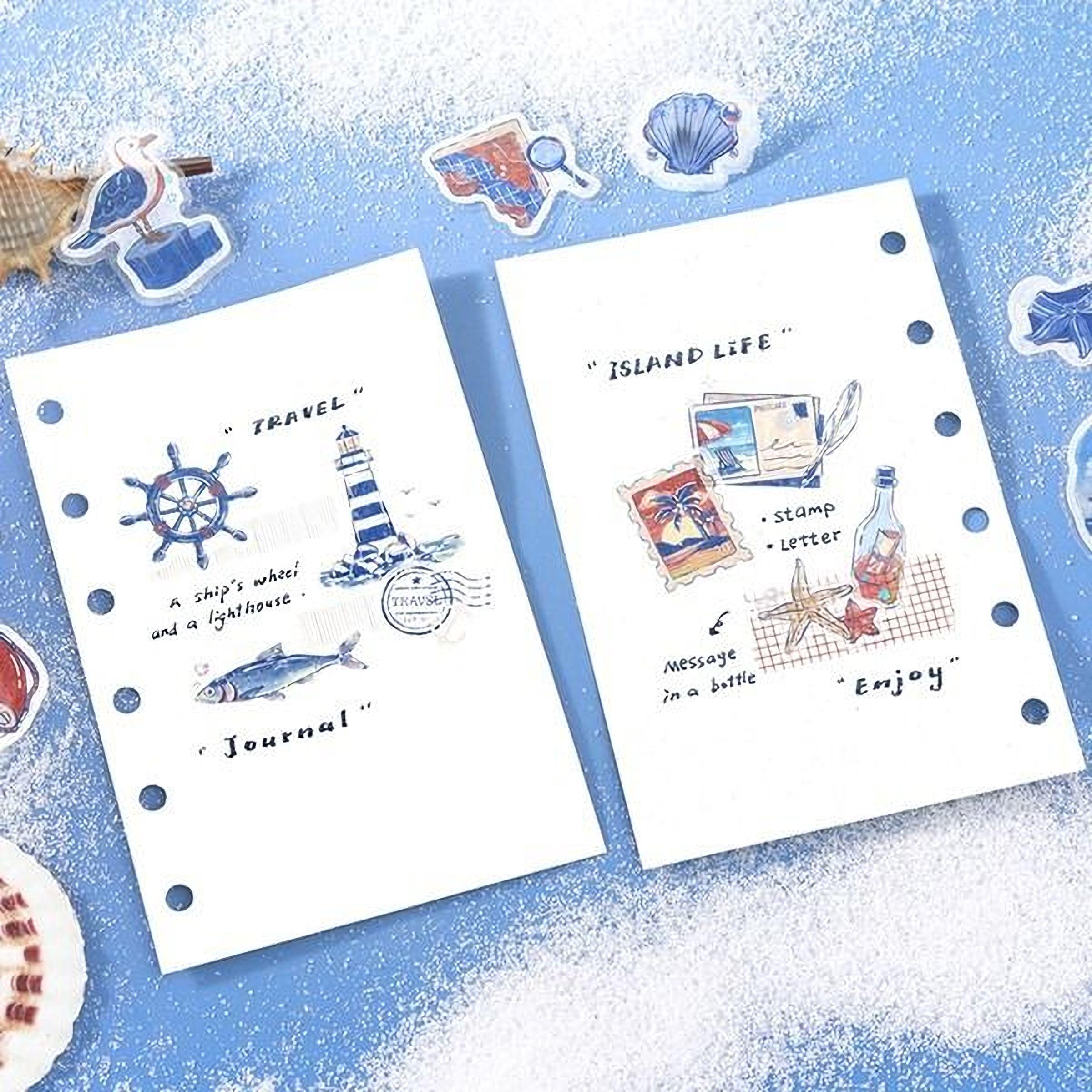 two notebooks with illustrations and text related to travel and island life, including a ship's wheel, lighthouse, stamps, a bottle, a message in a bottle, and a lighthouse.